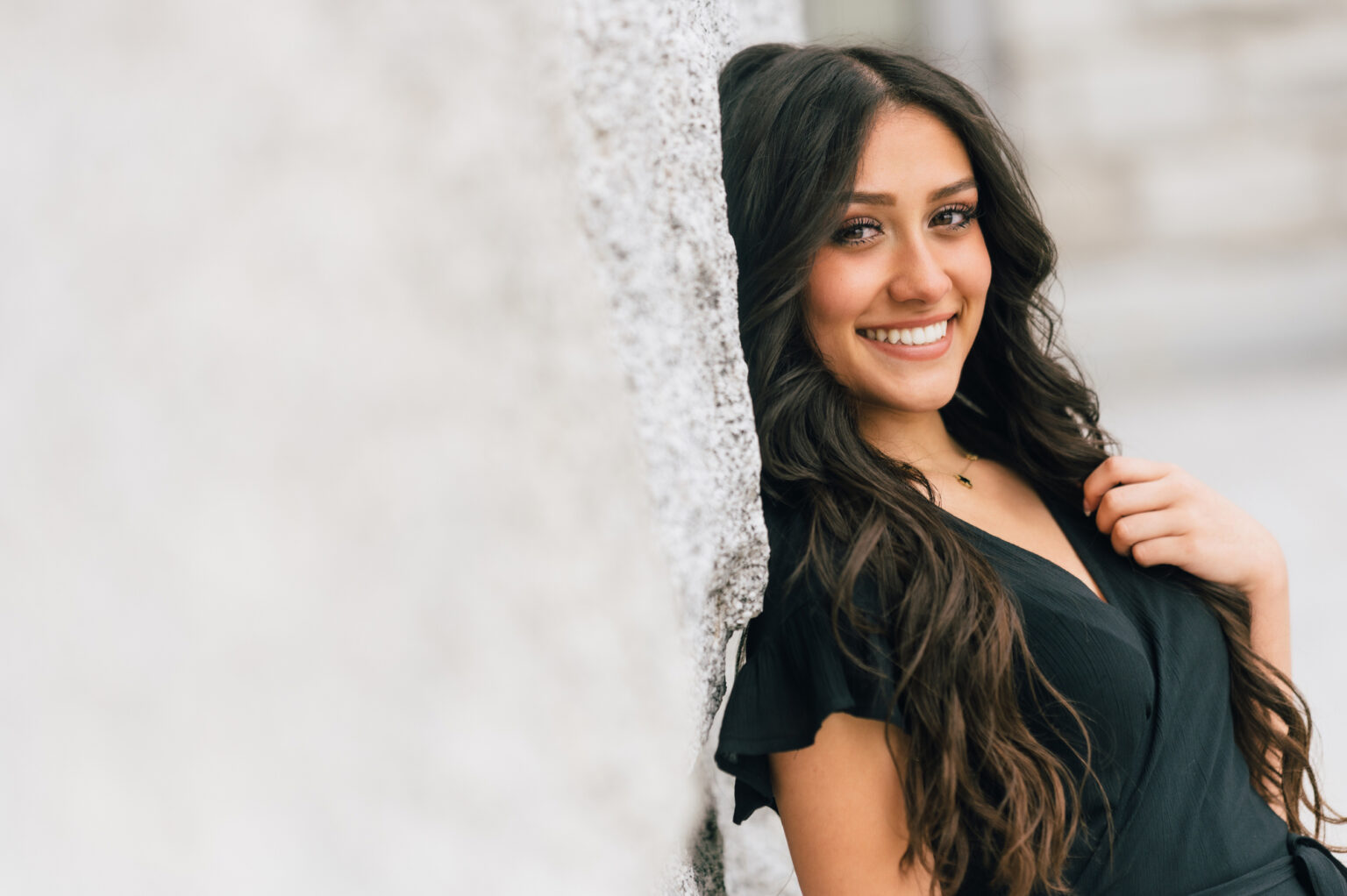 smiling teen patient leaning on wall outdoors