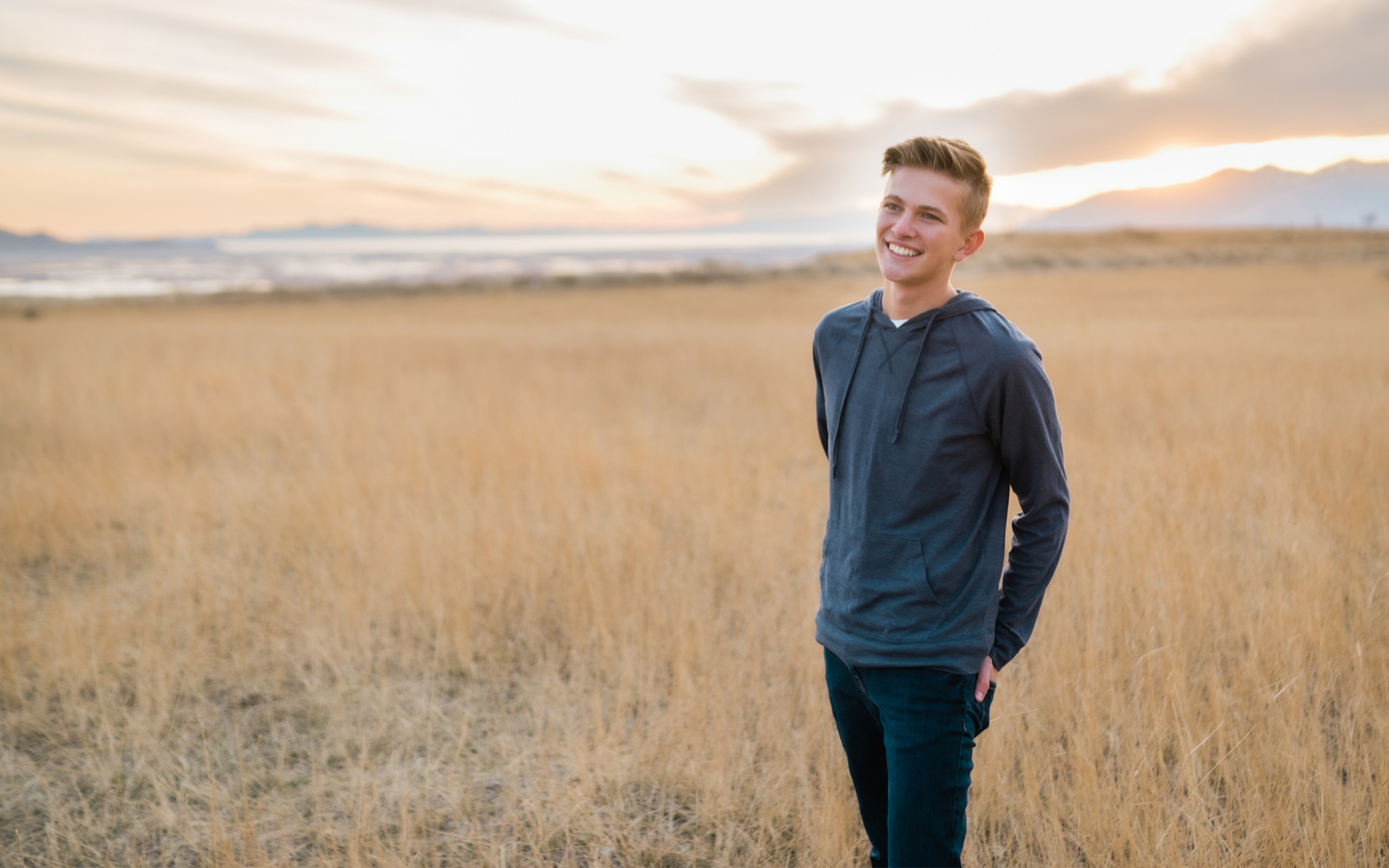 smiling male patient standing outdoors