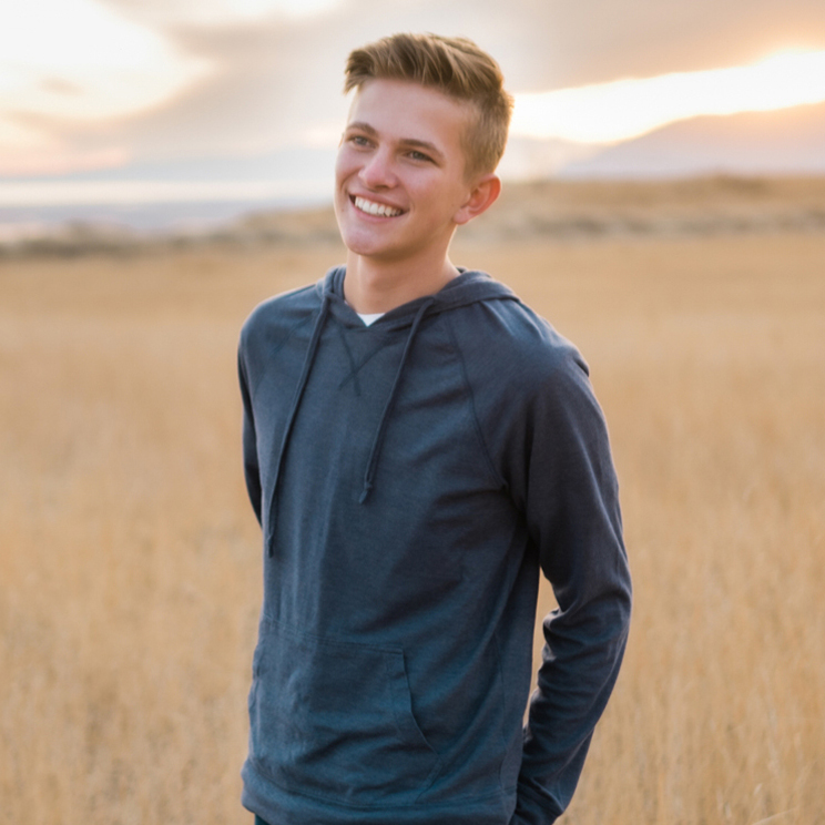 smiling male patient standing outdoors