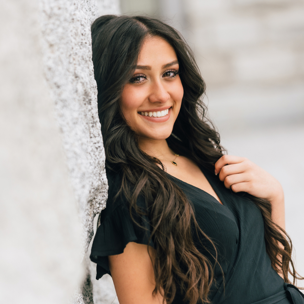 smiling teen patient leaning on wall outdoors